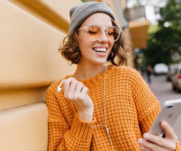 Smiling woman dressed in an orange sweater